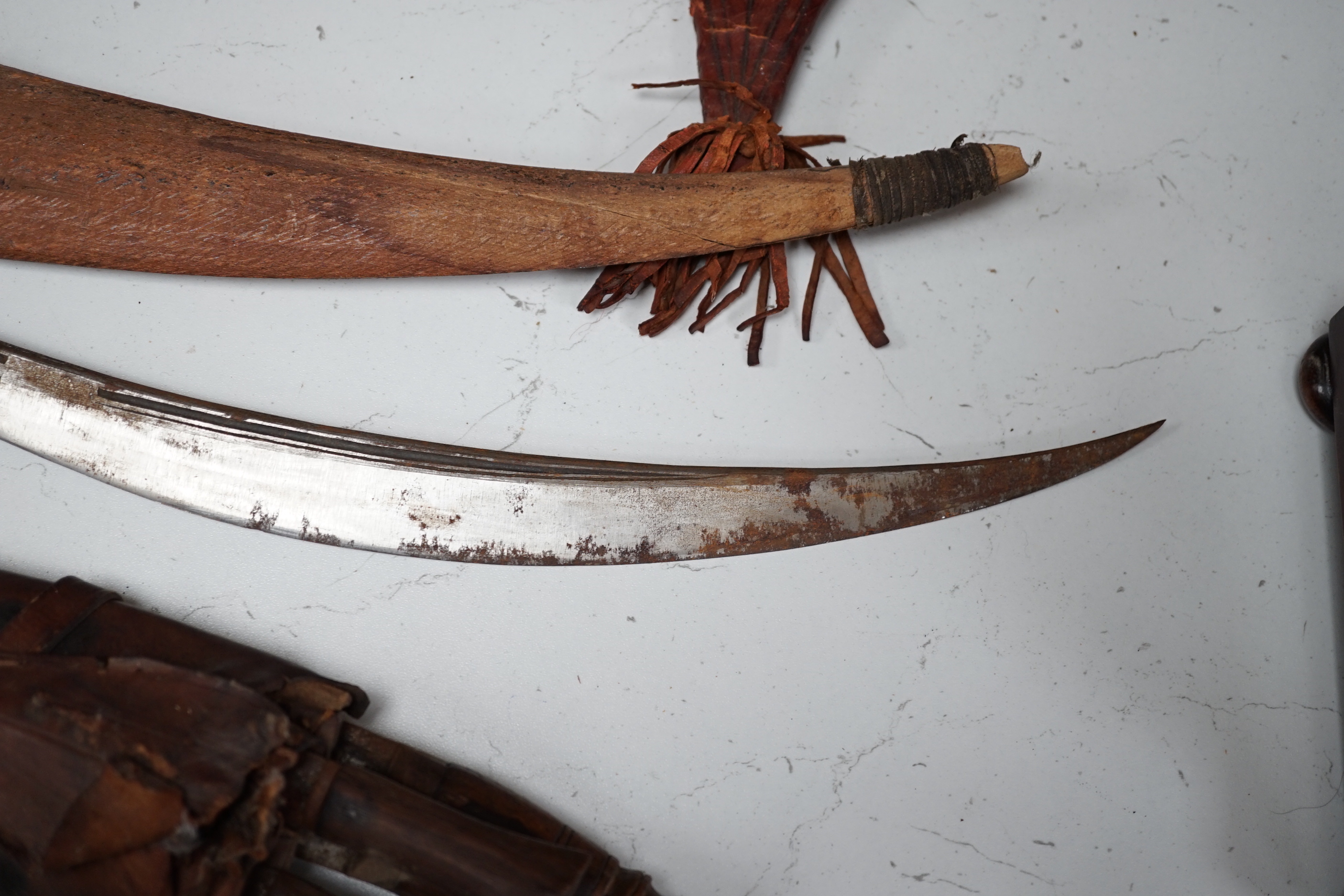 A kukri, a long dagger and sheath, a mace, and two African ebony busts